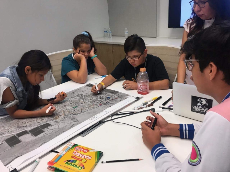 GRICUA youth plotting a map